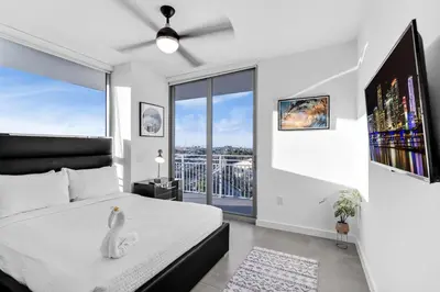 a bedroom with a white bed with a swan on it at Gorgeous 3-Bed Retreat Mins from Bayside and Parking in Miami