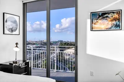 a bedroom with a large window with a view of a city at Gorgeous 3-Bed Retreat Mins from Bayside and Parking in Miami
