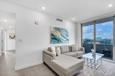 a living room with a couch and a table at Gorgeous 3-Bed Retreat Mins from Bayside and Parking in Miami