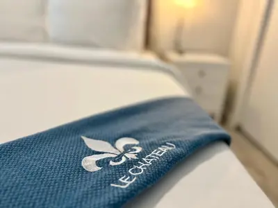 a blue towel on a bed in a room at Villa Michloe - Steps from Wilton Drive in Fort Lauderdale