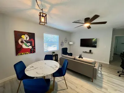 a living room with a couch and a table at Villa Michloe - Steps from Wilton Drive in Fort Lauderdale