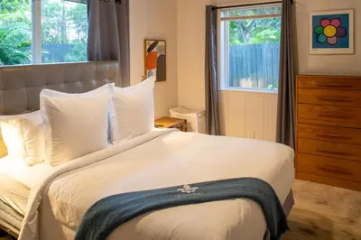 a bedroom with a bed with white sheets and a window at Walk to Wilton Drive - Spacious & Quiet Villa #2 HOT TUB! in Fort Lauderdale
