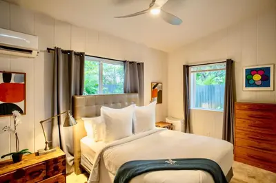 a bedroom with a large bed with white pillows at Walk to Wilton Drive - Spacious & Quiet Villa #2 HOT TUB! in Fort Lauderdale