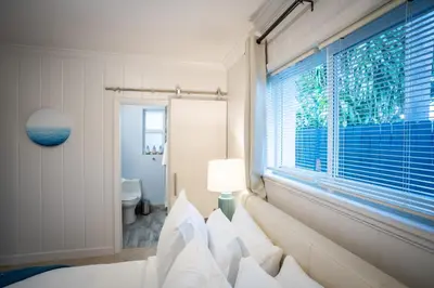 a bedroom with a window and a bed with pillows at Walk to Wilton Drive - Spacious & Quiet Villa #1 in Fort Lauderdale