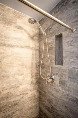 a shower in a bathroom with a stone wall at Walk to Wilton Drive - Spacious & Quiet Villa #1 in Fort Lauderdale
