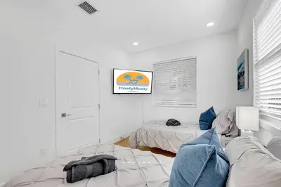 a living room with a couch and a bed at Villa Tropicale Stunning 4 Bedroom 4 Bath Home with Pool and BBQ in Miami