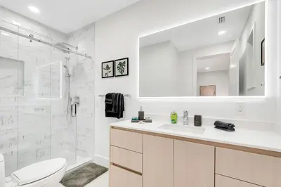a white bathroom with a sink and a shower at Villa Tropicale Stunning 4 Bedroom 4 Bath Home with Pool and BBQ in Miami
