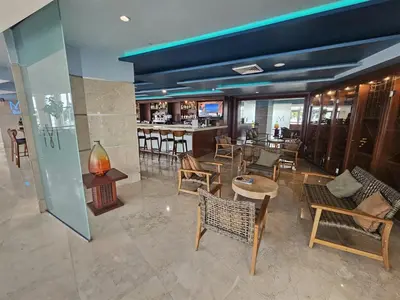 a restaurant with chairs and tables and a bar at Mare-1708 A in Aventura
