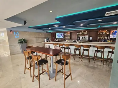 a bar in a restaurant with a wooden table and chairs at Mare-1708 B in Aventura