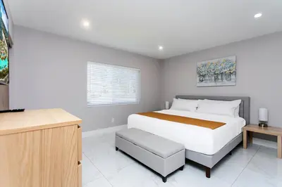 a bedroom with a large bed and a television at Premium Luxury 5BR & 3BA Villa near Hollywood Beach in Hollywood