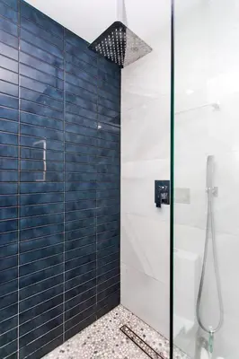 a bathroom with a shower with blue tiles at Premium Luxury 5BR & 3BA Villa near Hollywood Beach in Hollywood