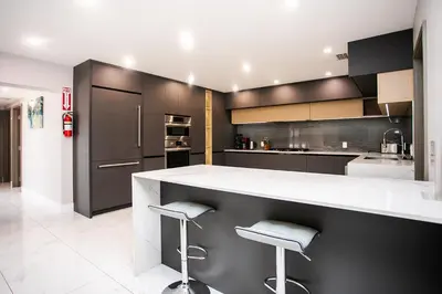 a kitchen with black cabinets and white counter tops at Premium Luxury 5BR & 3BA Villa near Hollywood Beach in Hollywood