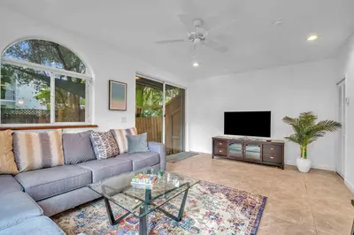 a living room with a couch and a tv at Center Grove - Lush & Spacious & New - 3 Bedrooms in Miami