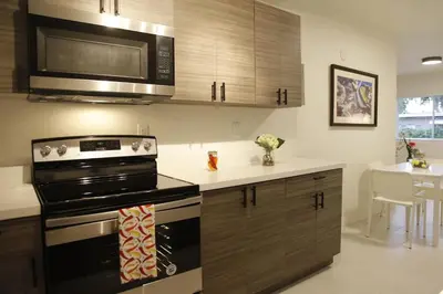 a kitchen with a stove and a microwave at Apt 4 Miami Designer Apartment in the Upper East-Side in Miami