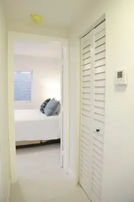 a white bedroom with a bed and a window at Apt 4 Miami Designer Apartment in the Upper East-Side in Miami