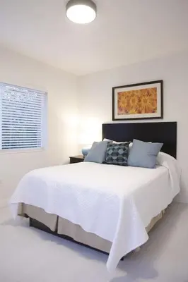 a white bedroom with a large white bed and a window at Apt 4 Miami Designer Apartment in the Upper East-Side in Miami