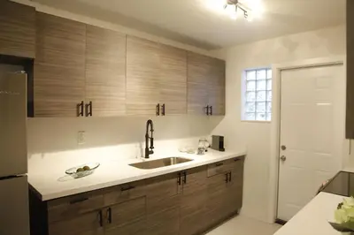 a kitchen with wooden cabinets and a sink at Apt 5 Miami Designer Apartment in the Upper East-Side in Miami