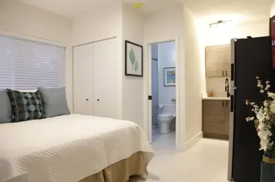 a bedroom with a bed and a bathroom with a toilet at Apt 6 Miami Designer Studio in the Upper East-Side in Miami