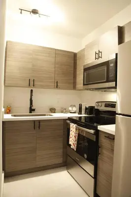 a kitchen with wooden cabinets and a sink and a stove at Apt 6 Miami Designer Studio in the Upper East-Side in Miami