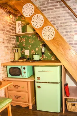 a small kitchen with a refrigerator and a microwave at Miami Tiny Vintage Cottage in Hialeah