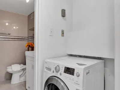 a white laundry room with a washing machine at Amazing Ocean View Condo Beach Service 1111 in Miami Beach