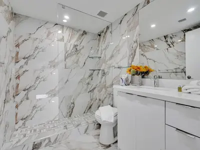 a white bathroom with a sink and a toilet at Ocean View Beachside Bliss Beach Service 1218 in Miami Beach