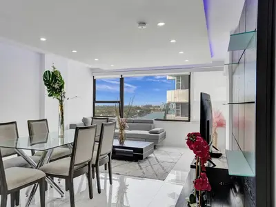 a dining room with a glass table and chairs at Ocean View Beachside Bliss Beach Service 1218 in Miami Beach