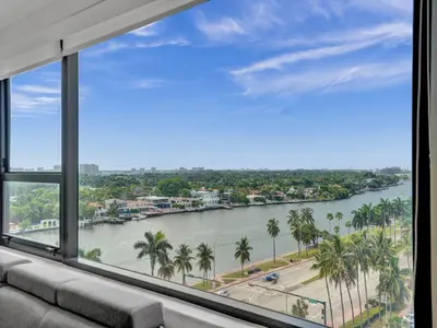 a room with a view of a river with palm trees at Ocean View Beachside Bliss Beach Service 1218 in Miami Beach