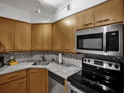 a kitchen with a sink and a microwave at Stylish Ocean Beach Retreat Beach Service 1009 in Miami Beach