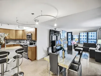 a kitchen and living room with a table and chairs at Stylish Ocean Beach Retreat Beach Service 1009 in Miami Beach