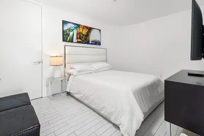 a white bedroom with a bed and a couch at Oceanview Private Home at South Beach-814 in Miami Beach