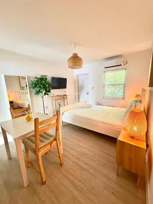 a large bedroom with a large bed and a table at Casa Agave Miami in Miami