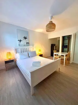 a bedroom with a large white bed and a table at Casa Agave Miami in Miami