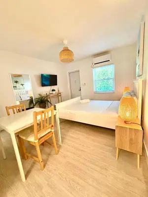 a large bedroom with a large bed and a table at Casa Agave Miami in Miami