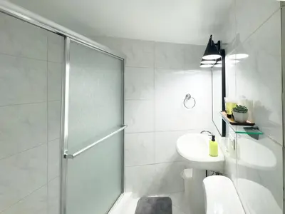 a bathroom with a shower and a toilet and a sink at The Octagon in South Beach in Miami Beach