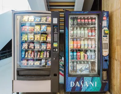 two soda machines are standing next to each other at Miami Beach Oceanfront in Miami Beach