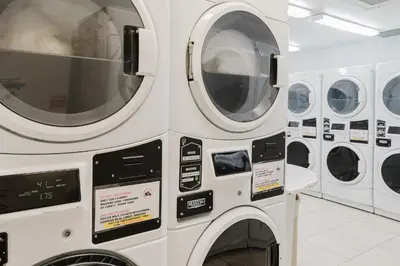 three washing machines are stacked next to each other at Miami Beach Oceanfront in Miami Beach