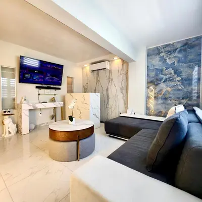 a living room with a couch and a table at Luxurious remodeled direct Waterfront apartment with Miami skyline view- Free parking- 5min drive to Miami Beach in Miami Beach