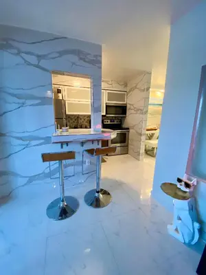 a kitchen with a table and a counter top at Luxurious remodeled direct Waterfront apartment with Miami skyline view- Free parking- 5min drive to Miami Beach in Miami Beach