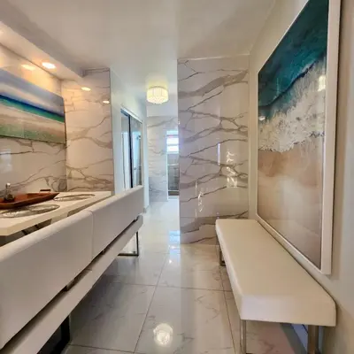 a bathroom with marble walls and a bench at Luxurious remodeled direct Waterfront apartment with Miami skyline view- Free parking- 5min drive to Miami Beach in Miami Beach