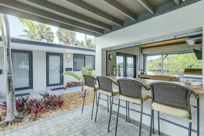 a patio with chairs and a table in a house at Waterfront Deck Pool Kayak in Fort Lauderdale