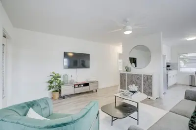 a living room with a blue couch and a table at Pool Access Free Parking Smart TV Wifi in Fort Lauderdale