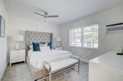 a white bedroom with a bed and a window at Pool Free Wifi Parking Smart TV in Fort Lauderdale