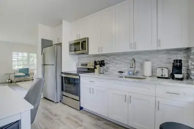 a kitchen with white cabinets and stainless steel appliances at Pool Free Wifi Parking Smart TV in Fort Lauderdale
