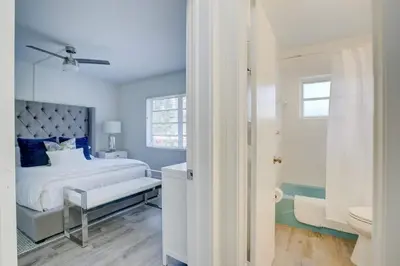 a white bedroom with a bed and a bathroom at Pool Free Wifi Parking Smart TV in Fort Lauderdale