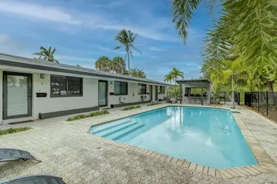 an image of a swimming pool in front of a house at Waterfront Apartment Private Patio Pool in Fort Lauderdale