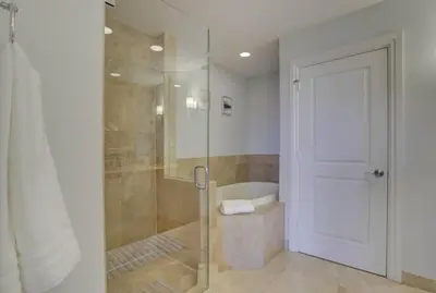 a bathroom with a shower and a glass door at Private Patio Cali King Bed Walk to Las Olas in Fort Lauderdale