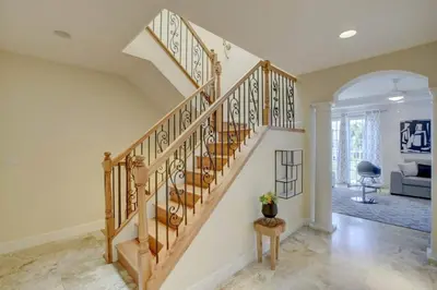 a staircase in a living room with a stair case at Private Patio Cali King Bed Walk to Las Olas in Fort Lauderdale
