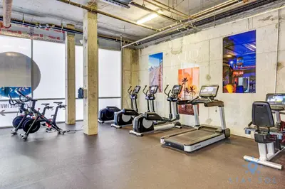 a gym with several treadmills and exercise bikes at Hollywood Beach Rooftop Pool Hot Tub in Hollywood