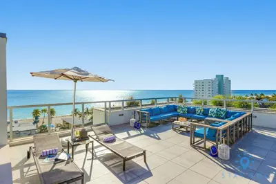 a balcony with a view of the beach at Hollywood Beach Rooftop Pool Hot Tub in Hollywood